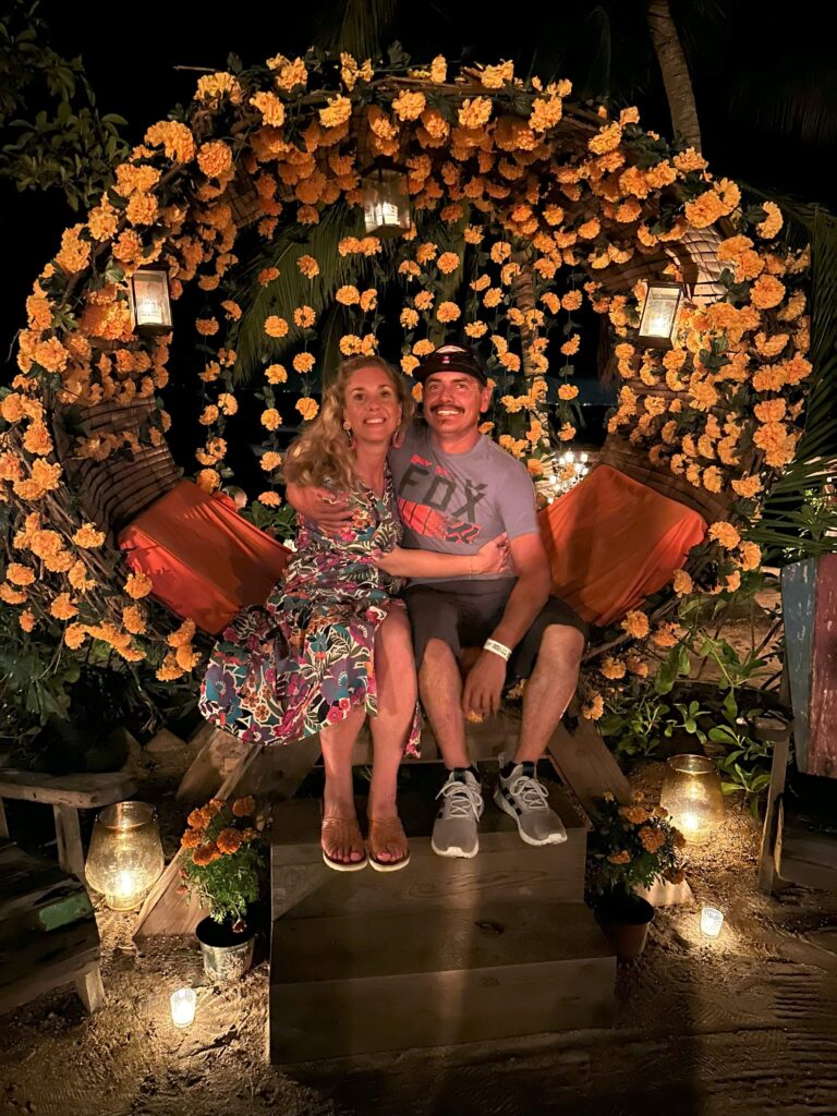 Morgz and Mario sitting in a chair at Las Caletas to celebrate Dia de los Muertos. 